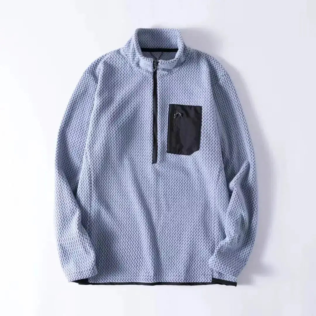 Unisex fleece sweatshirt with light gray wavy pattern, long sleeves, black chest pocket, quarter-zip.