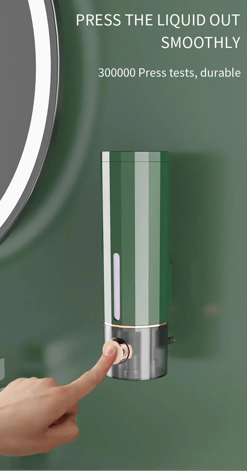 Manual wall-mounted soap dispenser in green with silver base for bathroom and hotel use