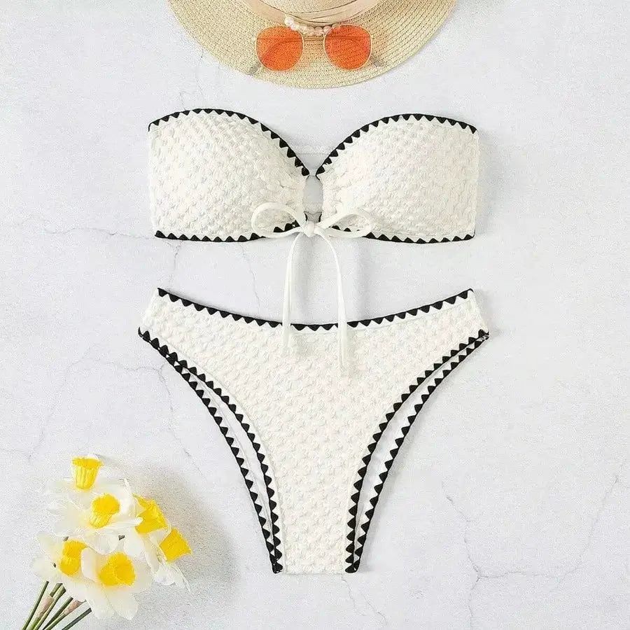 Two-piece white strapless bikini set by Simples Market with textured fabric and black trim