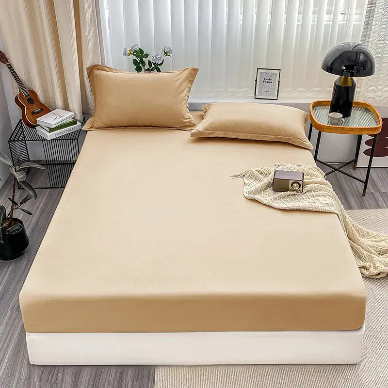 Fitted beige bed sheet with elastic anti-slip edges; solid color for single to king beds.