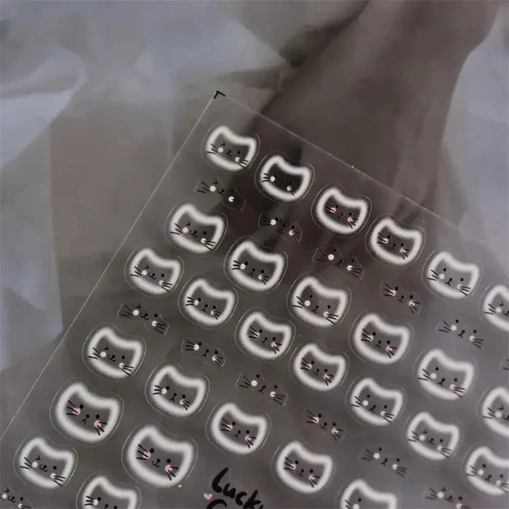 Cat face nail art stickers sheet with white halo cat faces for manicure; multiple decals
