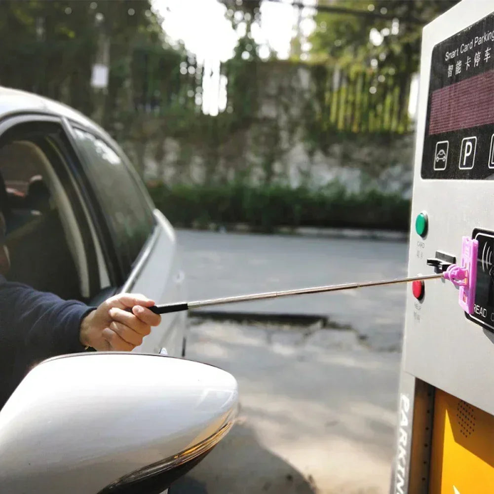 Car toll card stick by Simples Market; adjustable telescopic rod with pink grip for contactless parking payments.