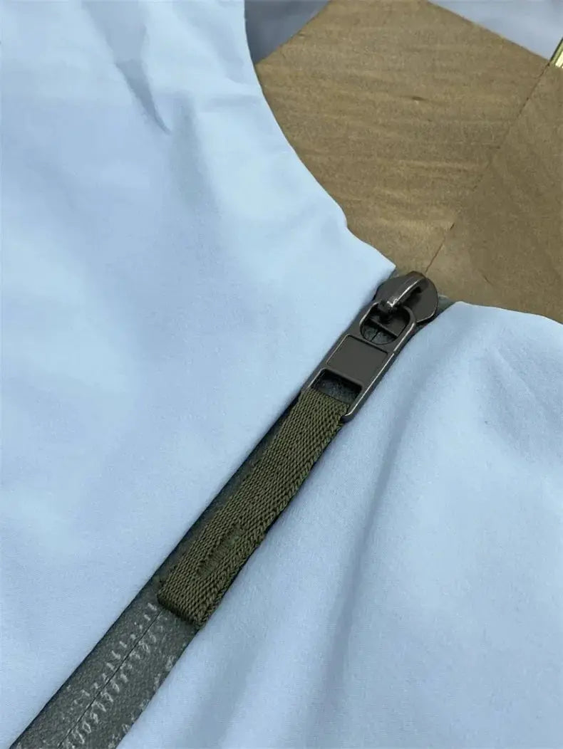 Outdoors jacket men's windproof soft-shell with light blue fabric, olive strap, and black zipper; Simples Market.