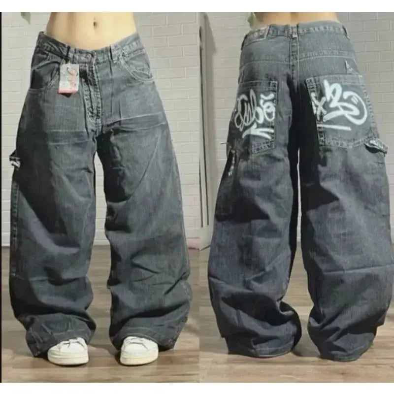 Men's oversized baggy jeans in gray denim with graffiti back pockets and wide legs.