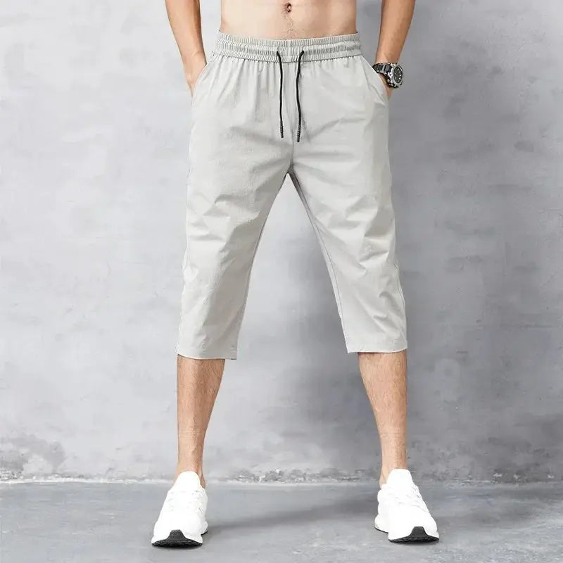 Men's 3/4 length shorts in light gray with elastic waist and drawstring; quick-dry nylon stretch Bermuda for summer
