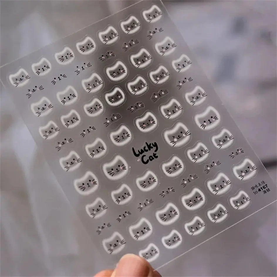 Nail art decals sheet featuring numerous white and gray cat-face stickers, with Lucky Cat branding
