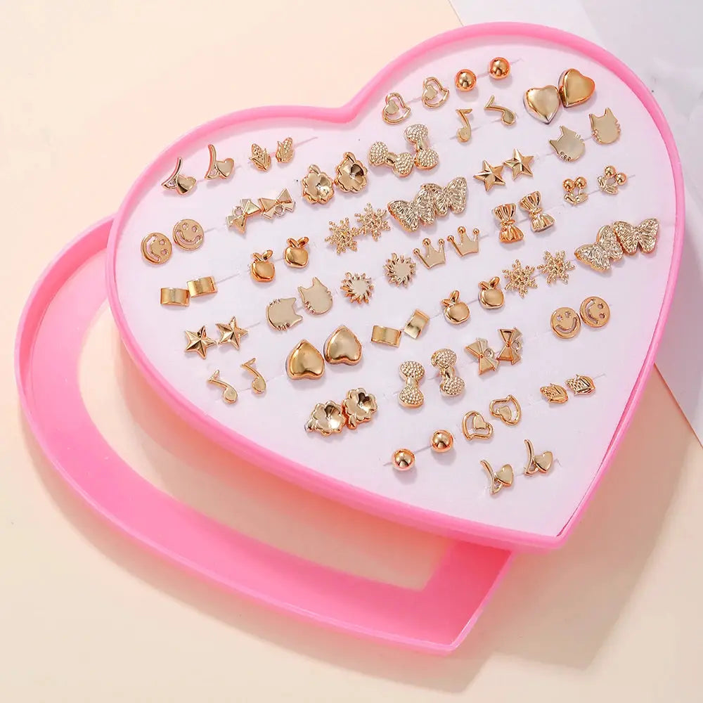 Gold-tone resin stud earrings set, 36 pairs in a pink heart box; shapes like snowflakes, butterflies, stars.