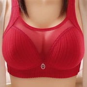 Red wireless bra with wide straps, padded cups and breathable mesh panels.