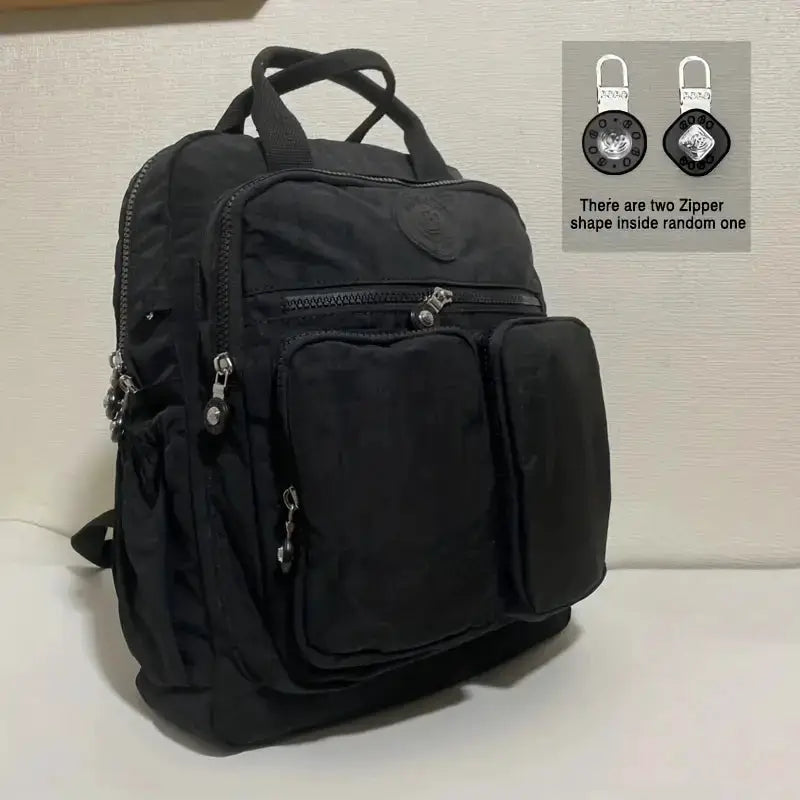 Backpack by Simples Market, black waterproof nylon with multiple pockets and soft carry handle
