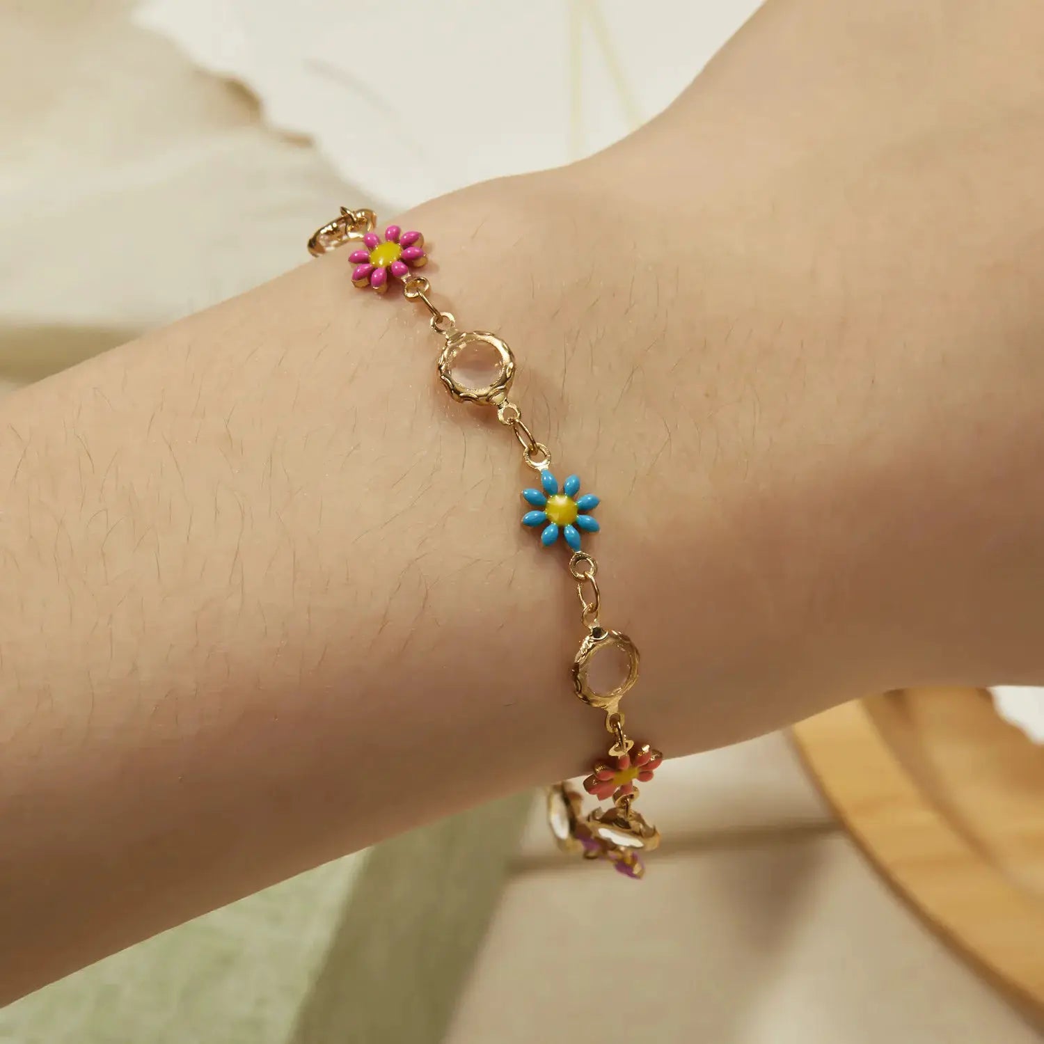 Sweet Daisy Flower Bracelet; gold-tone chain with pink and blue daisy charms