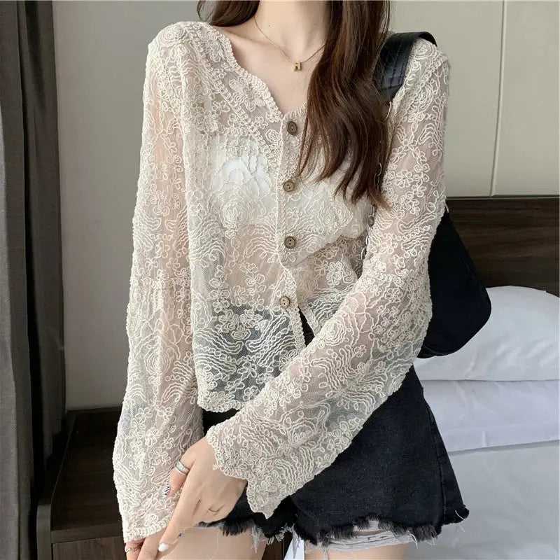 Vintage lace blouse by Simples Market, cream sheer long-sleeve top with floral pattern and brown buttons.
