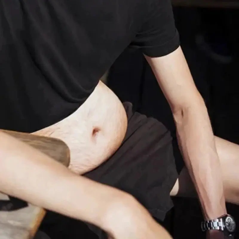 Flesh-colored Simples Market fanny pack worn at the waist on a man in a black shirt and shorts