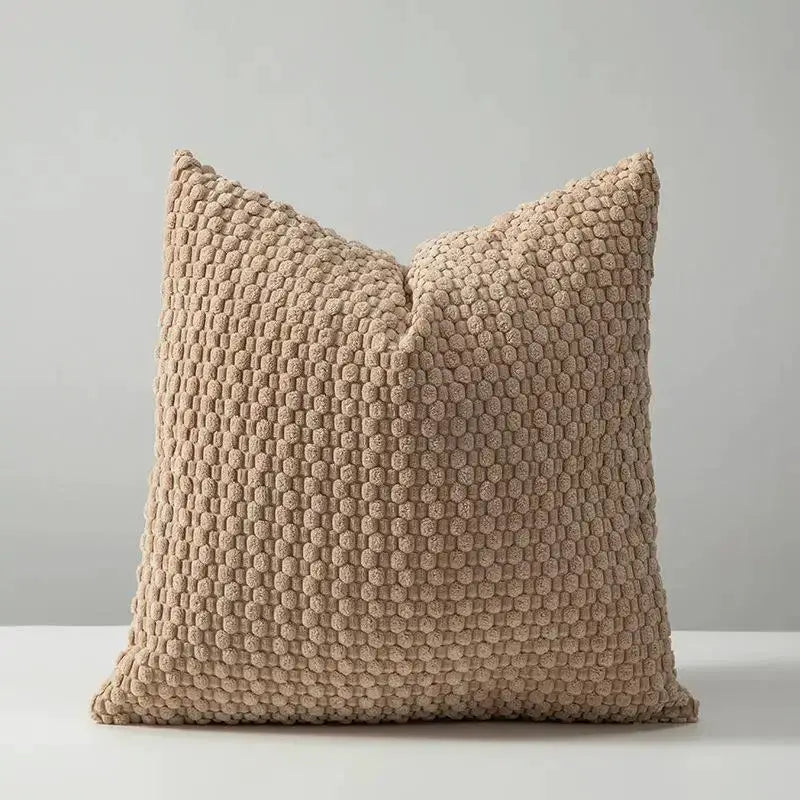 Soft velvet beige square cushion with a textured dotted surface