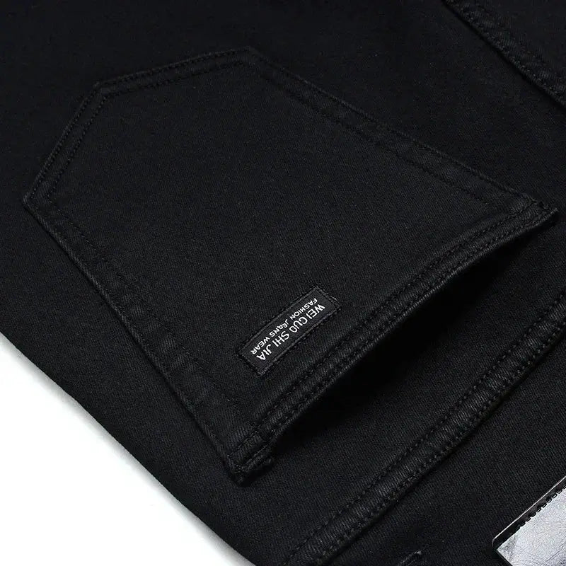 Men's black denim jeans pocket detail with Simples Market label, soft-stretch