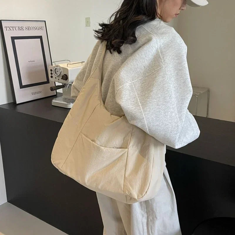 Trendy women's beige soft-cloth shoulder bag, oversized crossbody tote with front pocket.