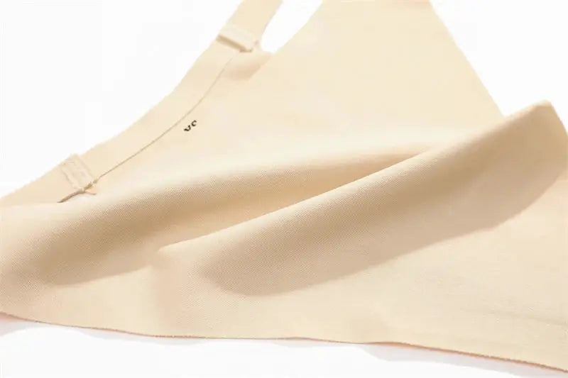 Beige seamless underwear fabric with thong-style strap; high-stretch silhouette