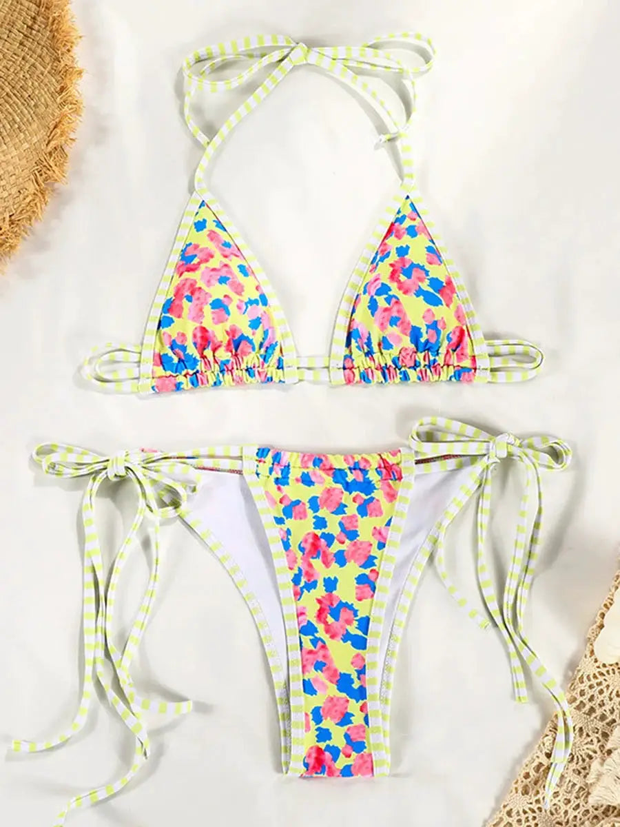 Simples Market two-piece bikini set in yellow floral print with pink and blue flowers; triangle top, tie-side bottoms.