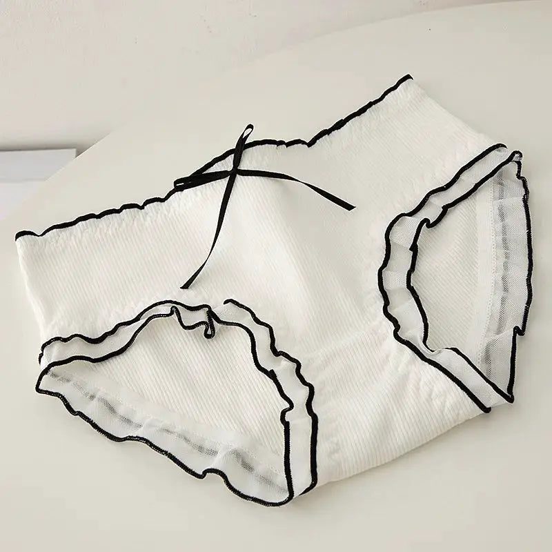 Women's white seamless lace panties with black trim and bow detail