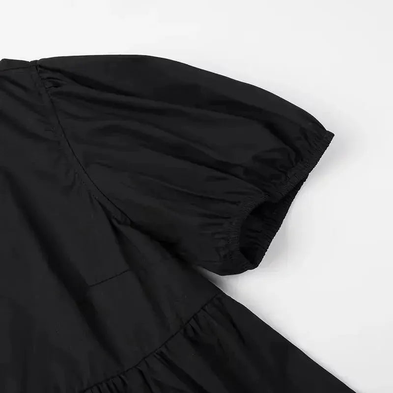 Black puff-sleeve blouse with elastic cuffs and gathered waist.