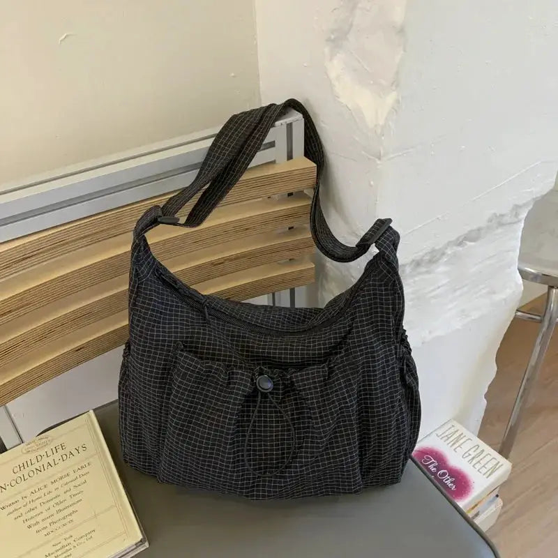Korean nylon shoulder bag in black plaid with drawstring, pleated front, crossbody strap