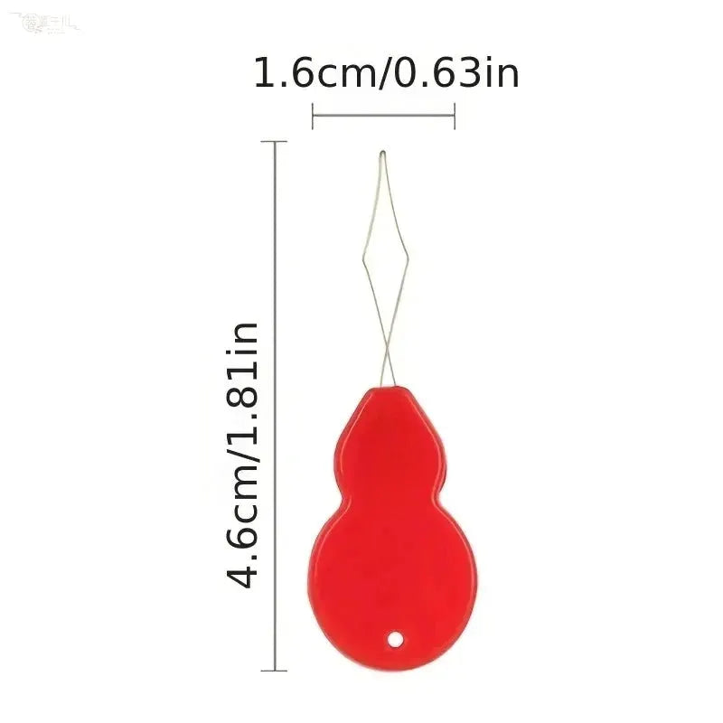 Plastic needle threader by Simples Market, red plastic body with metal wire threading loop, 4.6 cm long