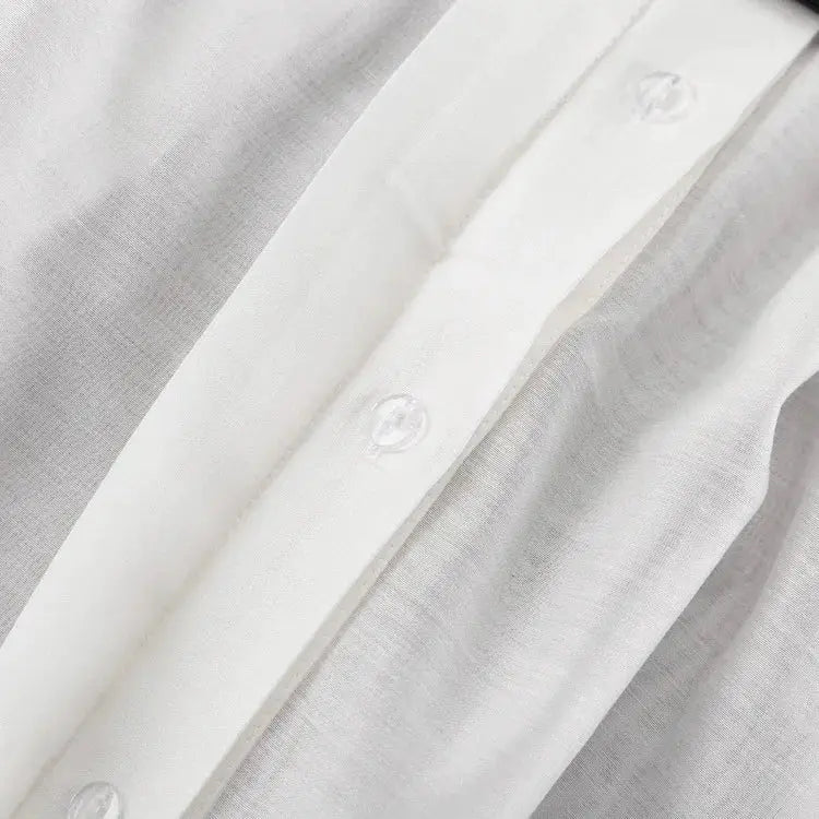 Women's white solid-color collared shirt with long sleeves and front button-down.