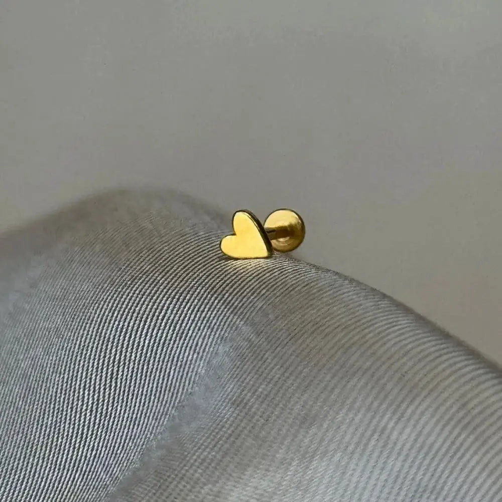 Heart-shaped gold-tone stud earring with ball backing