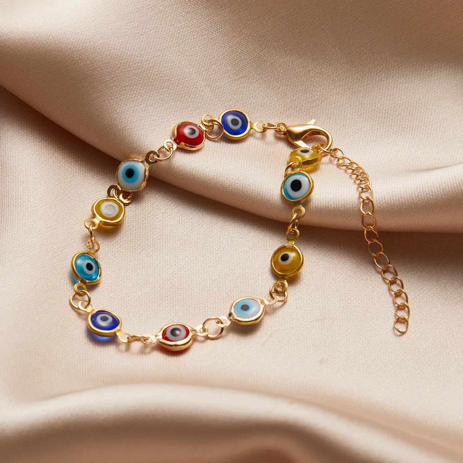 Lucky Turkey Evil Eye bracelet with colorful blue, red, and yellow charms on a gold adjustable chain