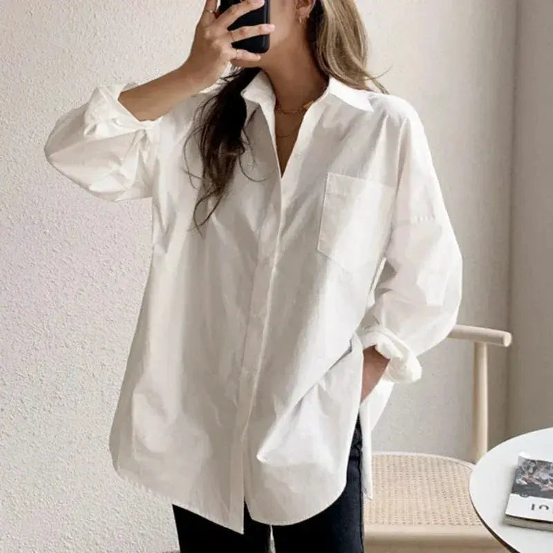White cotton long-sleeve blouse with turn-down collar, chest pocket, and loose fit