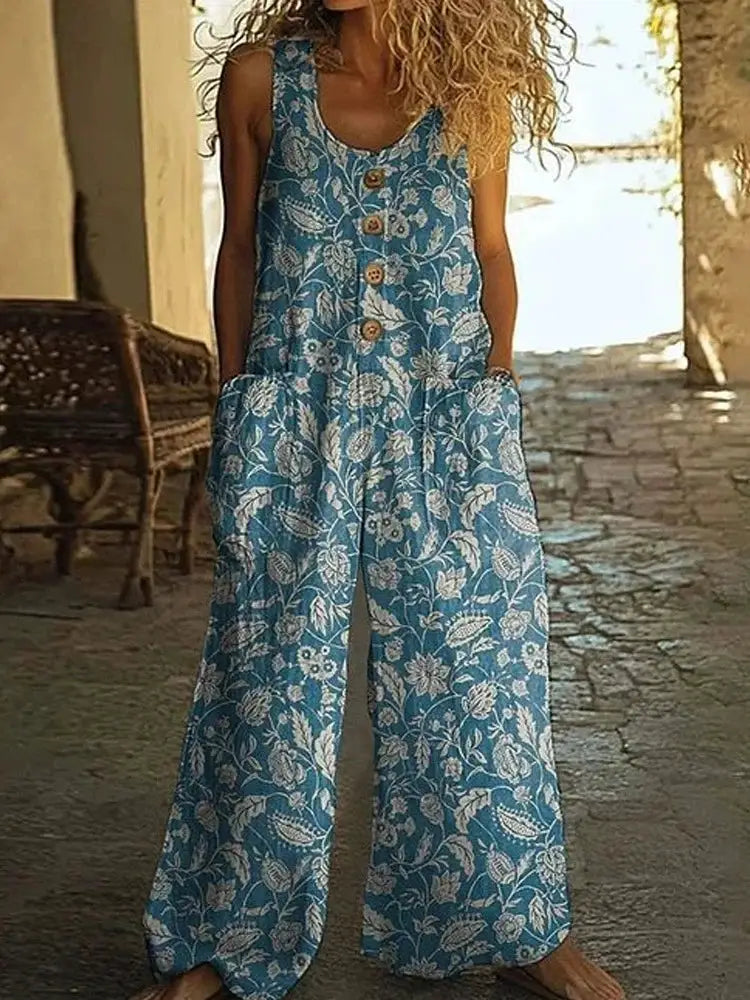 Sleeveless jumpsuit by Simples Market in blue floral fabric with button front and wide-leg pants