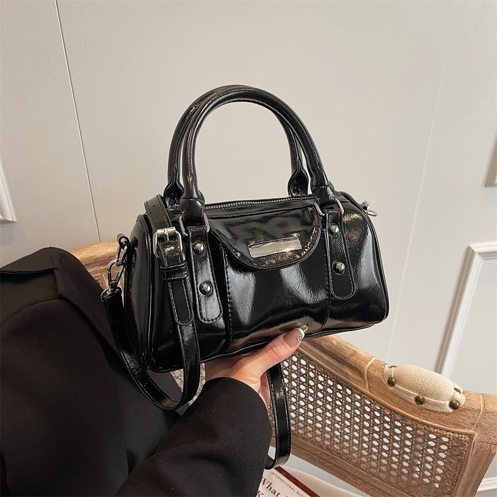 Mini top-handle bag in black glossy PU leather with silver hardware and detachable crossbody strap