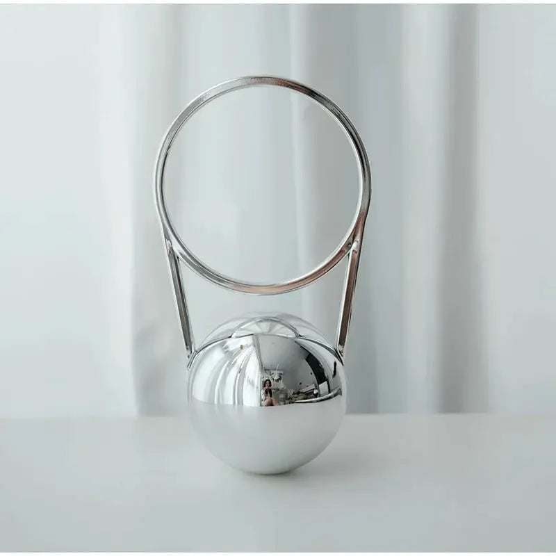 Luxury acrylic evening clutch with circular chrome ball-handle frame in silver