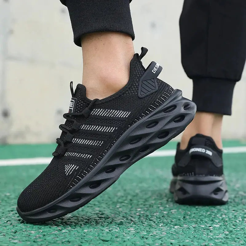 Pair of black Simples Market running sneakers with a knit mesh upper and thick sculpted sole.