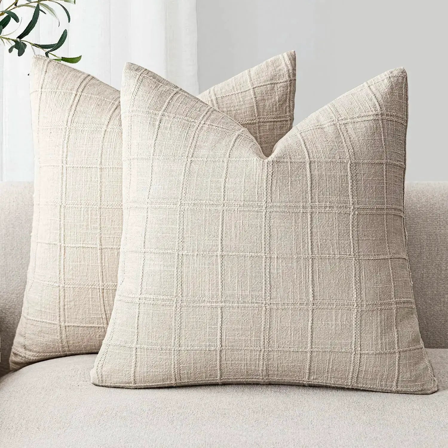 Two beige linen square cushion covers with a subtle grid pattern, 40x40 cm
