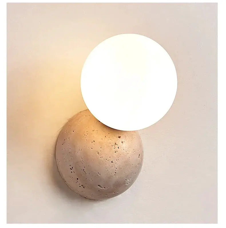Wall-mounted LED lamp with round white disk atop beige stone base, Nordic cream-style bedside light