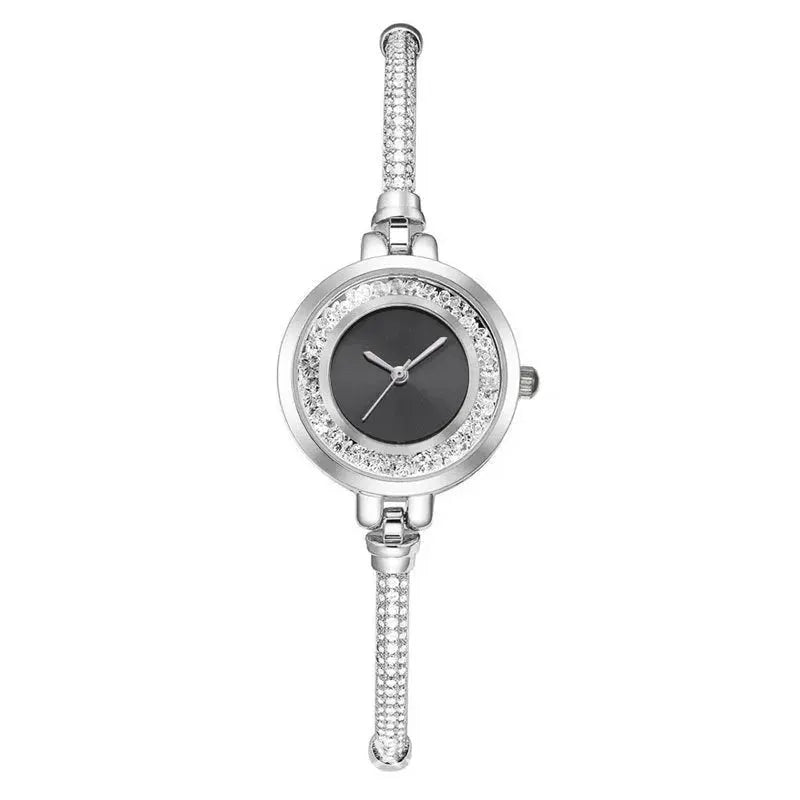 Women's silver bracelet wristwatch with crystal-studded bezel and black dial, quartz movement