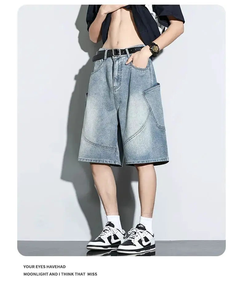 Baggy light-wash denim shorts with large front pockets, knee-length, belt, worn with sneakers.
