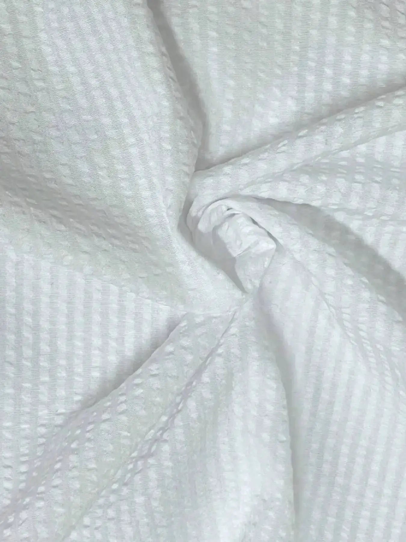 Men's long-sleeve shirt in white textured fabric with a subtle dot pattern