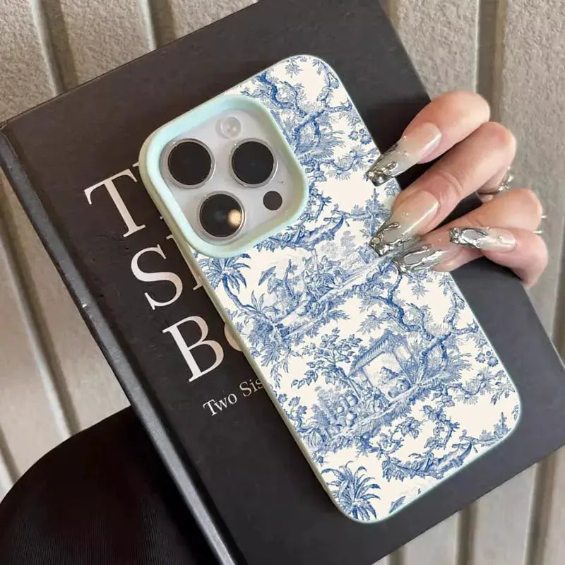 Simples Market phone case for iPhone with blue and white toile pattern, soft shockproof cover and light blue border.