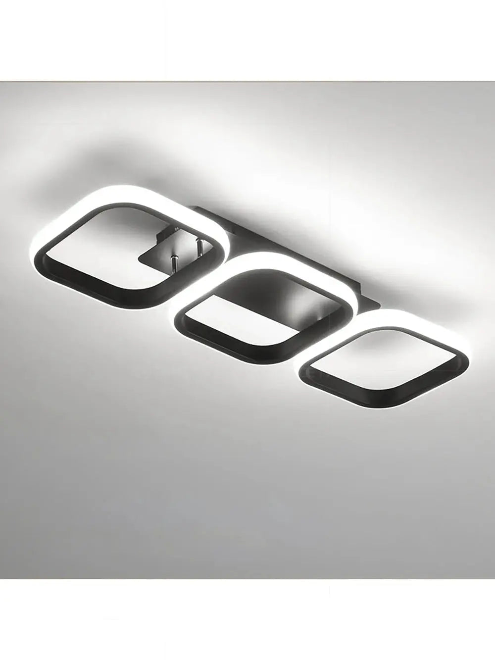 LED ceiling light by Simples Market, modern black metal fixture with three illuminated rounded-square rings.
