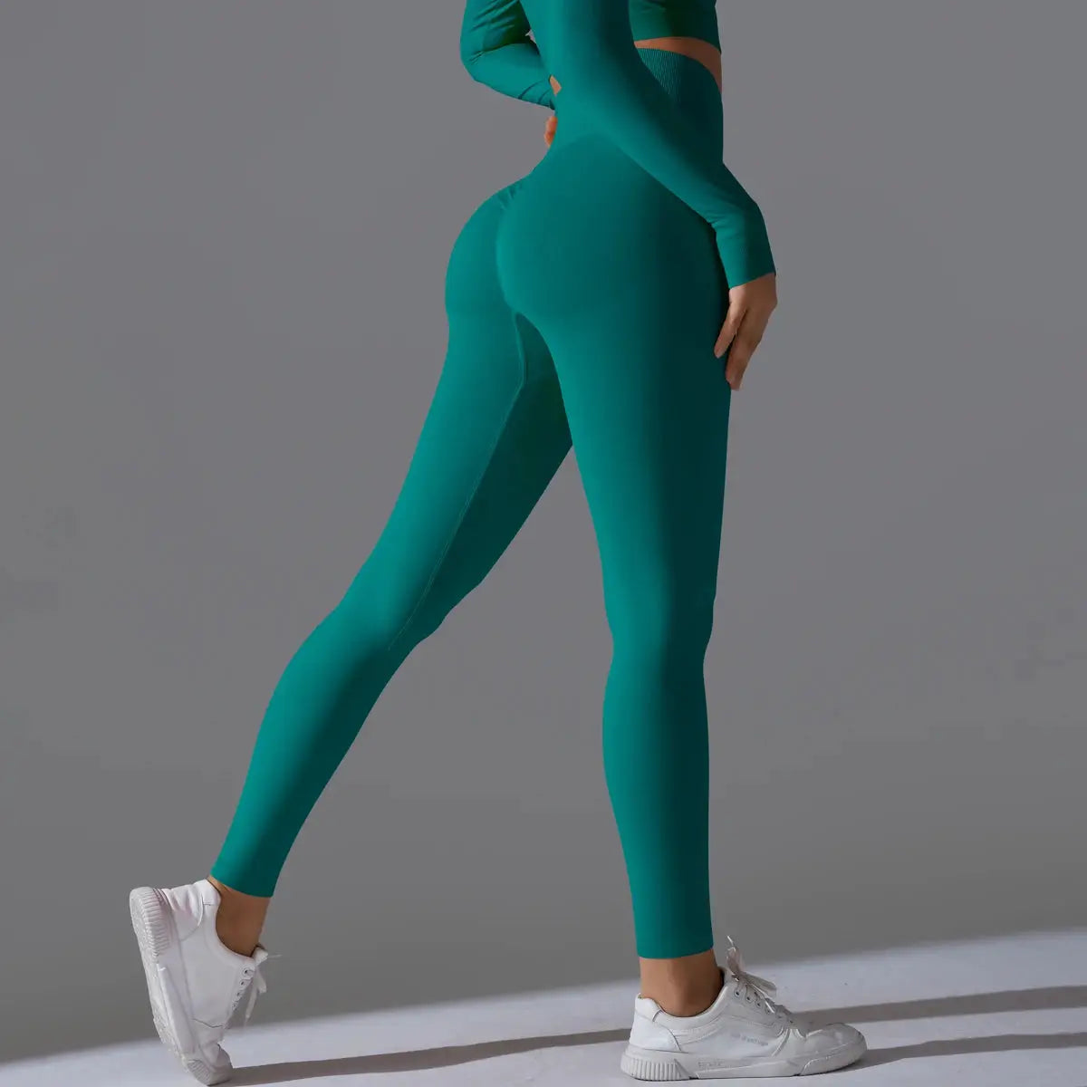 Women's teal seamless yoga leggings with high waist, tummy control, and scrunch butt lift for gym workouts