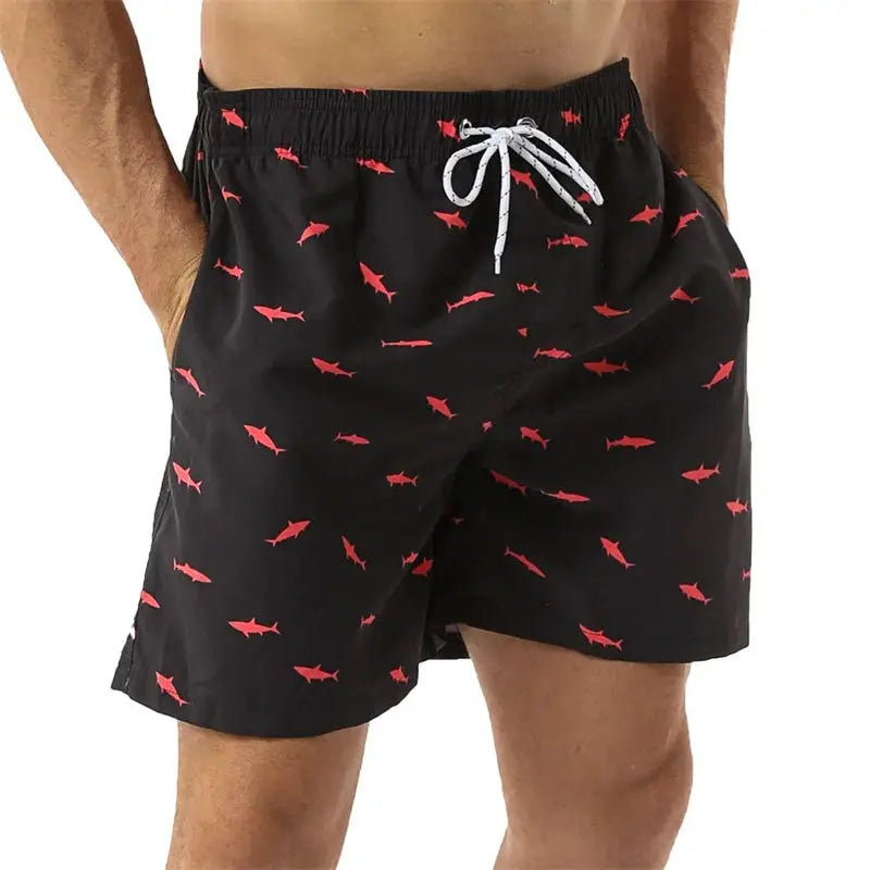Men's black swim trunks with red shark pattern and white drawstring waistband