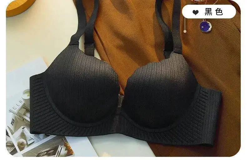 Push-up bra in black ribbed fabric with thick padding and wide adjustable straps