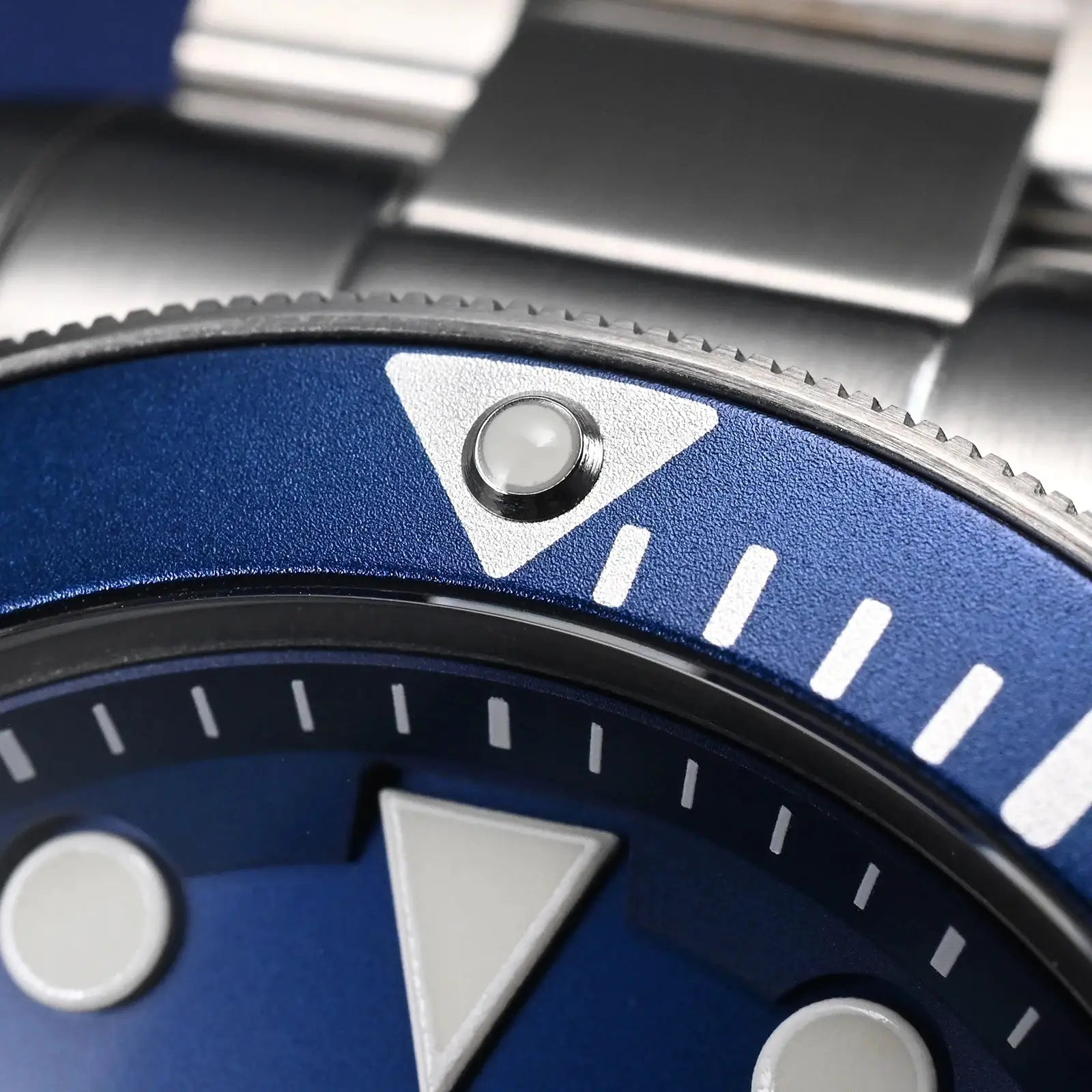 Watchdives WD1969 Pro blue 38mm diver watch bezel close-up with a luminescent pip and white markers