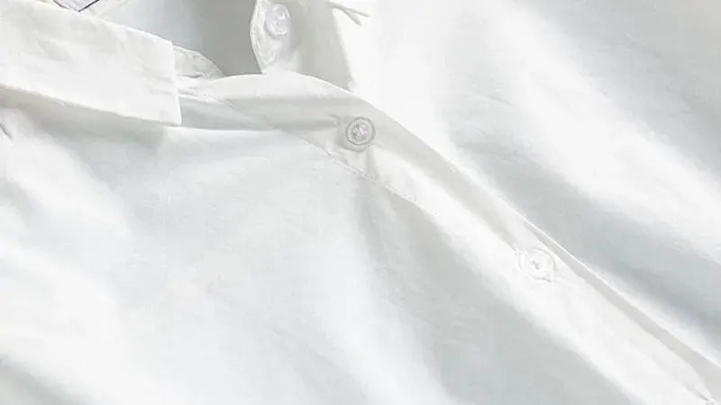 White women's long-sleeve button-up shirt with collar.