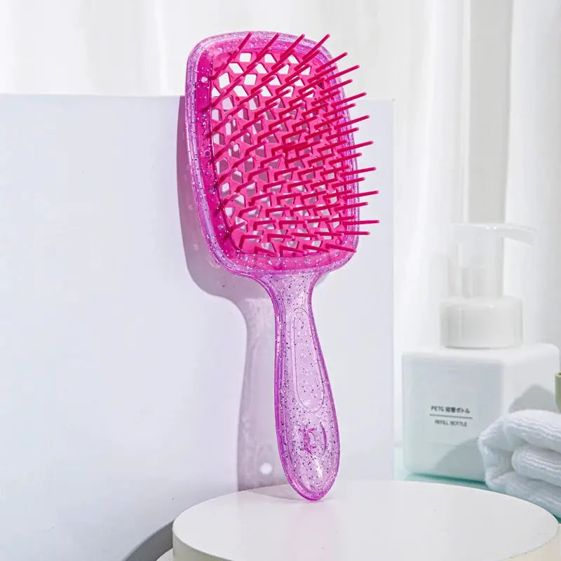 Pink plastic detangling hair brush with hollow-out grid and massage teeth