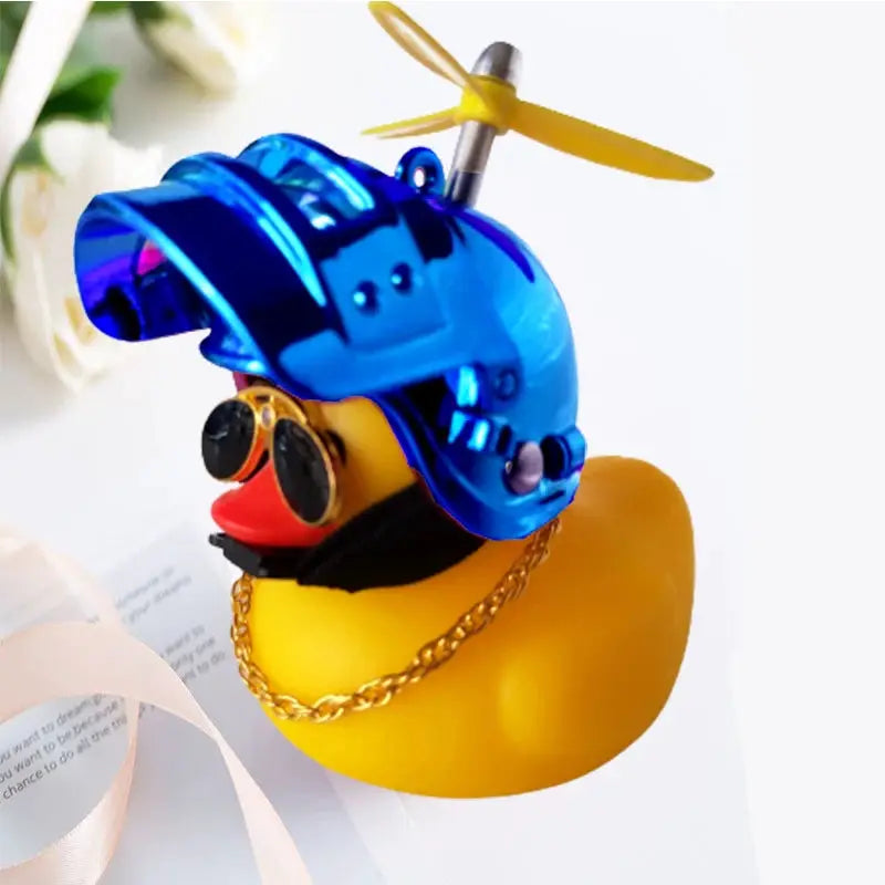 Yellow rubber duck car accessory wearing a blue helmet with propeller for car interior decoration