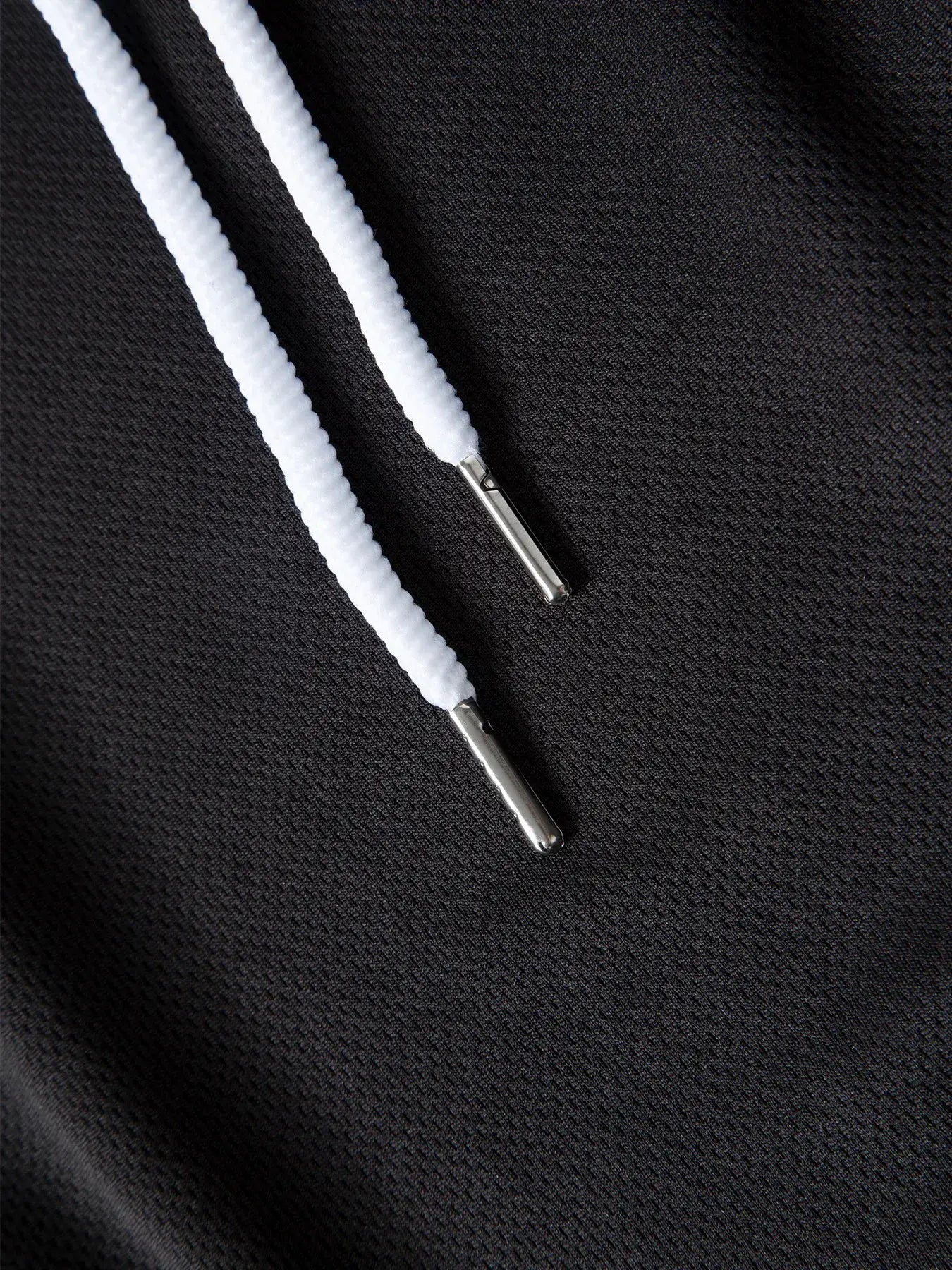 Men's basketball shorts by Simples Market; black mesh quick-dry fabric with white drawstrings and metal aglets.