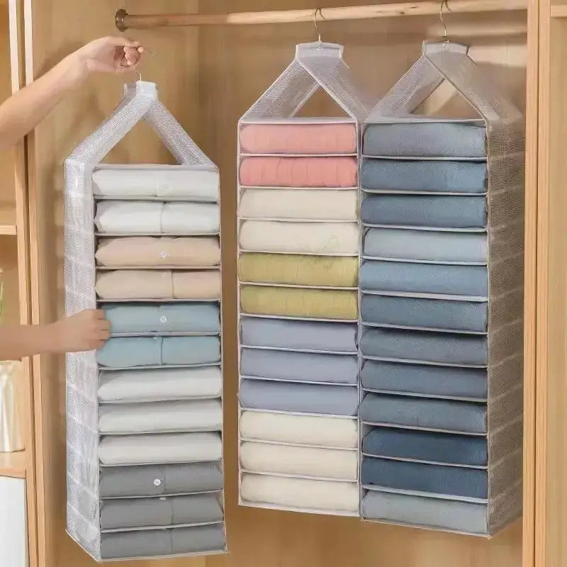 Hanging closet organizers, two gray mesh units with fabric pockets holding folded pastel clothes