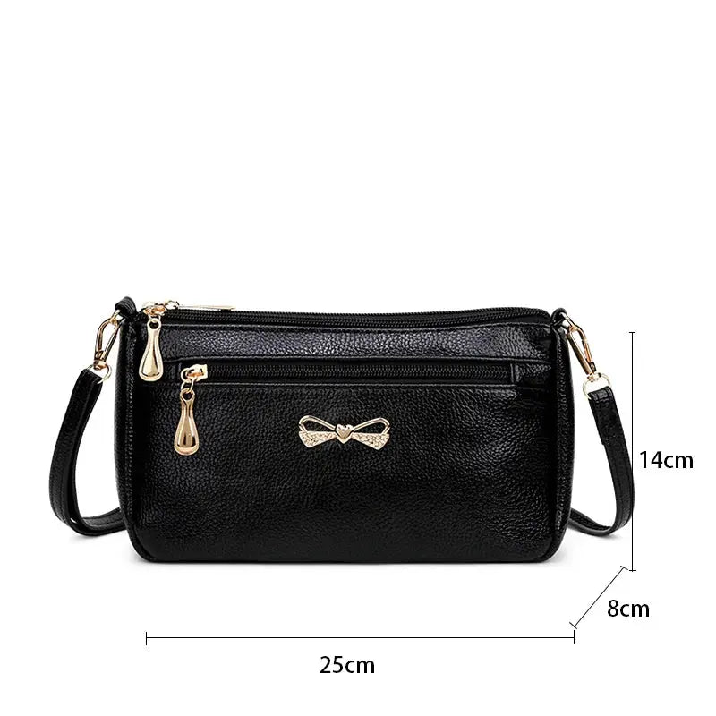 Simples Market black PU leather women's shoulder crossbody bag with gold bow charm and front zipper pocket, 25x14x8 cm